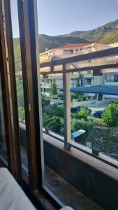 a window with a view of a parking lot at Petrovac in Petrovac na Moru