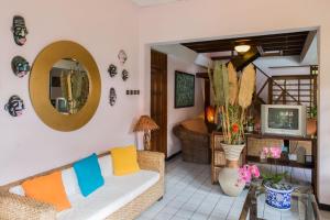 a living room with a couch and a mirror at Duta Garden Hotel in Yogyakarta