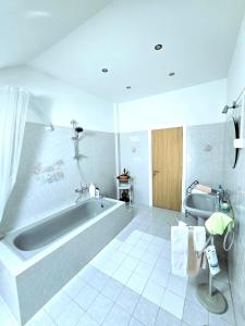 a white bathroom with a tub and a sink at Bulle Entre Parenthèses in Aroeira +57 photos