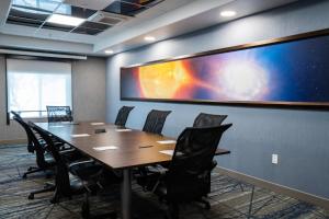 a conference room with a large projection screen on the wall at Holiday Inn Express Las Cruces North by IHG in Las Cruces +37 photos