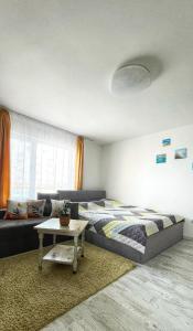 a bedroom with a bed and a couch and a table at Studio Kikki Sozopol in Sozopol