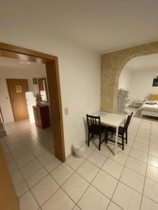 a kitchen and dining room with a table and chairs at Kirchberg Comfort Rooms in Luxembourg
