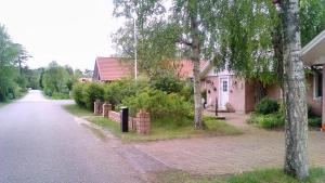 a brick road with a house and trees on the side at Pärlebo in Mellbystrand