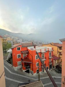 an orange building with a view of a city at Casa Meri in Villagrande Strisaili +5 photos