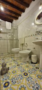 a bathroom with two toilets and a teddy bear on the floor at Casa Dalia in Montecatini Terme
