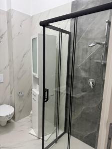 una ducha con puerta de cristal en un baño en Topazio blu, en Alghero 10 fotos más