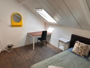 a bedroom with a desk and a bed and a mirror at Stay In Aveiro in Aveiro