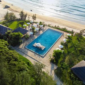 an overhead view of a swimming pool next to a beach at Crown Retreat Quy Nhon Resort in Quy Nhon