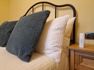 a bed with two pillows on top of it at Failte Stay in Inverness
