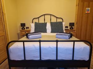 a bed with blue and white sheets and pillows at Failte Stay in Inverness +25 photos