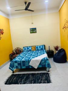 a bedroom with a bed and a ceiling fan at Sangrag Homestay in Guwahati