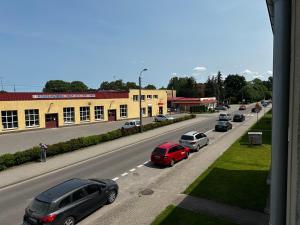 a street with cars parked on the side of a road at Apartament u Magdy in Giżycko