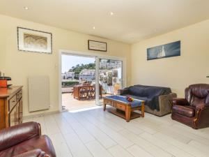 a living room with a couch and a table at Apartment Cala Salionc by Interhome in Cañet de Mar +17 photos