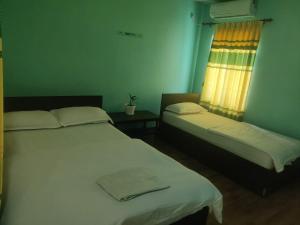 Postel nebo postele na pokoji v ubytování Ruru Riverside Hotel
