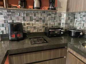 a kitchen counter with a toaster oven and a microwave at Cancun Plaza Condo Mexico in Cancún