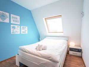 a small bedroom with a white bed with a window at Apartment Residentie Irena app-302 by Interhome in Bredene +13 photos