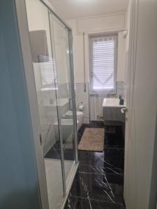 a bathroom with a shower and a sink and a toilet at PORTA A MARE STATION in Pisa +13 photos