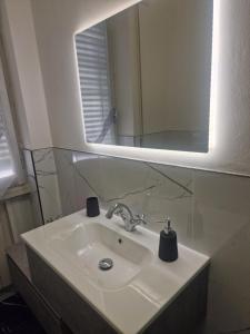 a bathroom with a sink and a mirror at PORTA A MARE STATION in Pisa +12 photos
