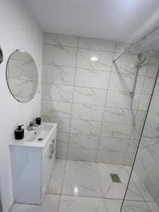 a white bathroom with a shower and a sink at Cabana NEST in Bistricioara +25 photos