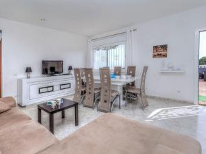 a living room with a table and chairs and a television at Holiday Home Mercury by Interhome in Lloret de Mar