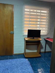 a desk with a laptop computer on top of it at Hostal Mi Casa in Canela Baja