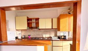 a kitchen with yellow cabinets and a sink in it at Altavista Rovato in Rovato +19 photos