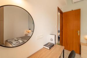 a mirror in a room with a bed and a table at Dream Apartments 3 in Palaiochóra +43 photos