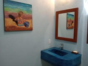 a bathroom with a painting of a woman in a tub at Rancho Camote - Diego Studio in Chichimilá +8 photos