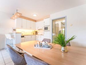 a kitchen and dining room with a wooden table and chairs at Studio Studio by Interhome in Bredene