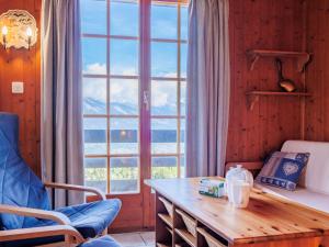 a room with a table and a large window at Chalet Tsamandon 22 by Interhome in Nendaz +30 photos