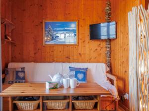a wooden wall with a table and a tv at Chalet Tsamandon 22 by Interhome in Nendaz