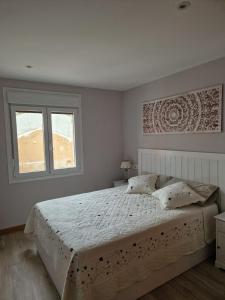 a bedroom with a large bed and a window at Casa Rural Casa Leni in Hontoria de Valdearados