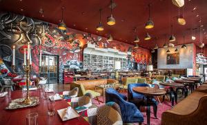 a restaurant with tables and chairs in a room at Art Downtown Fulton Market Entire 3 bedroom Home Sleep10 Private Garage Roof EV Tesla in Chicago