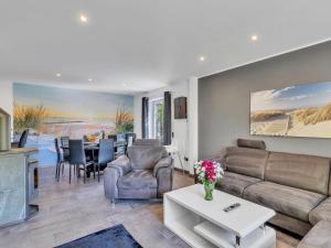a living room with a couch and a table at Holiday Home Landliebe by Interhome in Wingst