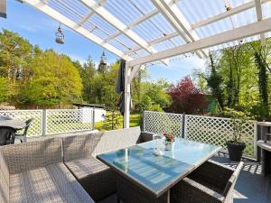 a patio with a table and chairs under a pergola at Holiday Home Landliebe by Interhome in Wingst