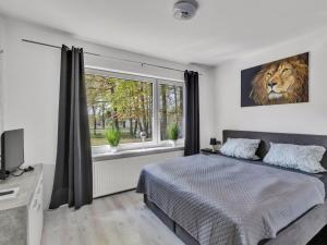 a bedroom with a bed and a large window at Holiday Home Landliebe by Interhome in Wingst