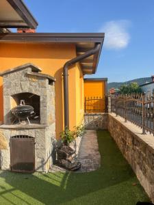 a patio with a stone oven on the side of a house at Summer house with terrace and free private parking in Koper