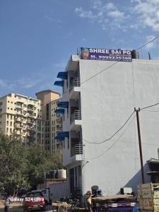a white building with a sign on the side of it at Shree Sai Stay in Gurgaon