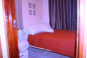 a bedroom with two beds and a mirror at Kar Kwe in Kisumu