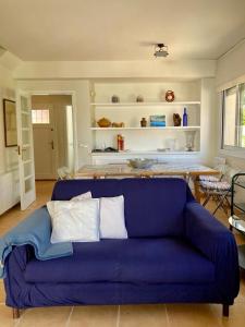 a blue couch sitting in a living room at Confort al cor de Calella in Palafrugell