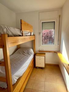 a bedroom with two bunk beds and a window at Confort al cor de Calella in Palafrugell +28 photos
