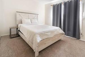 a bedroom with a large bed and a window at Urban Casita in Los Angeles