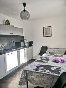 a kitchen with a table with flowers on it at MAWAROOMS in Świeradów-Zdrój +17 photos