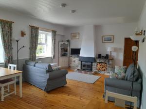 a living room with a couch and a fireplace at North Headborough in Haverfordwest