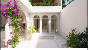 a house with flowers on the side of it at One room Villa - Le petit palace in Brisas de Zicatela