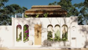 a white building with windows and a door with plants at One room Villa - Le petit palace in Brisas de Zicatela