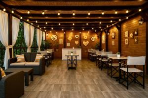 a restaurant with tables and chairs and lights at Pensiunea Konfort in Baile Felix