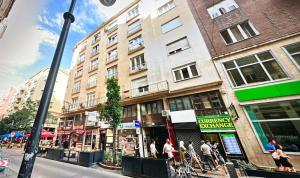 a group of people walking down a city street at Little Americas New York Rooftop Terrace in Budapest