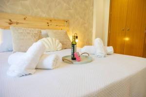 a bed with a bottle of wine and a candle on it at El Silillo Burunchel in Cazorla