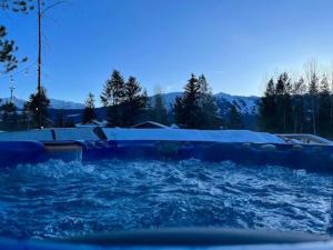 a pool of water with snow on top of it at The White House in Golden
